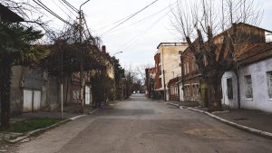 An empty street with a few buildings on both sides